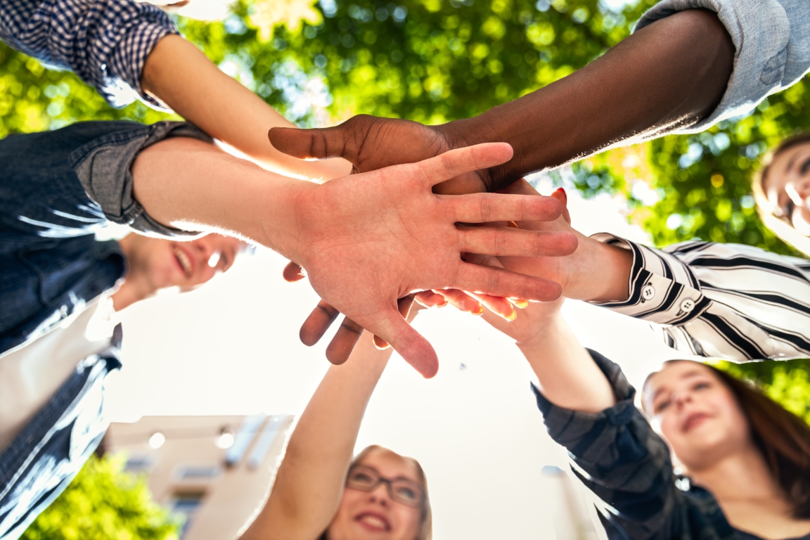 hands-tower-of-caucasian-and-afro-american-friends-together-outdoors-on-the-hot-sunny-spring-day hands-tower-of-caucasian-and-afro-american-friends-together-outdoors-on-the-hot-sunny-spring-day